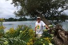 Richard Norcross rests from pulling invasive plants amoung the goldenrod.