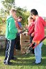 Matignon High School students use teamwork to load cuttings into brown bags for pickup.