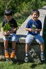 The brothers show off their bark boats made with findings from Elizabeth Island obtained for Fun Day.