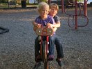 Alder and Cairn Hutton Johnson enjoy riding the new motorcycle in the playground.