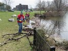 BU alumni cleaned up natural debris at the water's edge of Spy Pond at Linwood Circle.