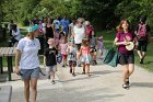 Liz Buchanan, musician, and Lauren from Tinkergarten lead a parade of nature-crowned children and adults through the park to the dedication of "Penny" the swan sculpture by Kevin Duffy at Linwood Circle.