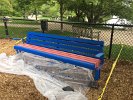 Anthony Vogel,winner of Spy Pond Park and Arlinton Public Art's design contest, applied new colors to the tot lot bench in Spy Pond Park