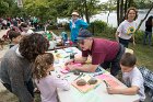 Colin Blair, Betsy Leondar-Wright (Fun Day Chair), and Lisa Berman (in back) guided children solving puzzles, playing paper games, and engaging in a scavenger hunt after which Dick Norcross awarded them prizes for their participation