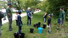 Curtis Puncher, Cub Scout Den #313, and their fathers listened closely to Lally Stowell’s instructions about watering the new trees on the Minuteman Trail embankment adjacent to Spy Pond Park