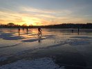 This January 2018 sunset photo captures some of the activities on frozen Spy Pond that included skating, ice fishing, cross country skiing, ice sailing, hiking, dog walking, and bicycling