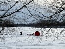 The sunshine through the haze didn’t warm the fishers who were prepared to duck into their red shanty in the cold, February weather.
