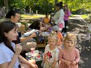 Children lined up at the face-painting station where FSPP volunteers painted colorful rainbows, butterflies, and creative designs on happy faces like for twins (l-r) Adeline and Aileen.
