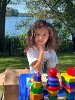 Learning about nature up close, Olivia explored barred owls with a book and a cuddly owl friend at the children’s activity table.